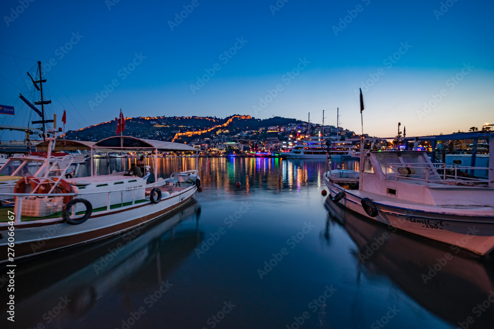 Alanya city, Turkey at night from the pier. Night view of the city of Alanya. Berth for ships.
