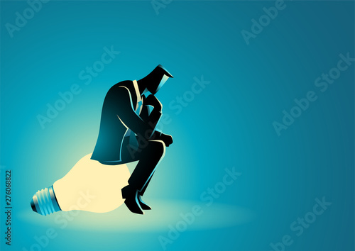 Businessman sitting and thinking on light bulb