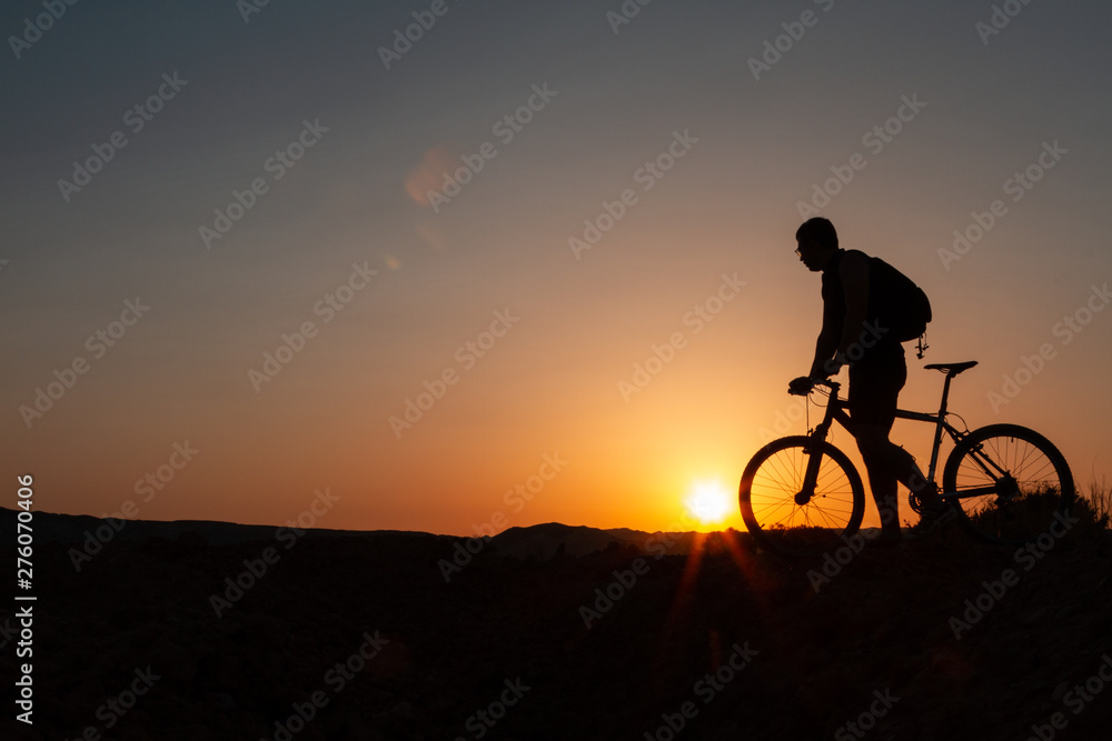 Man with mountain bike at sunrise Man with mountain bike at sunrise