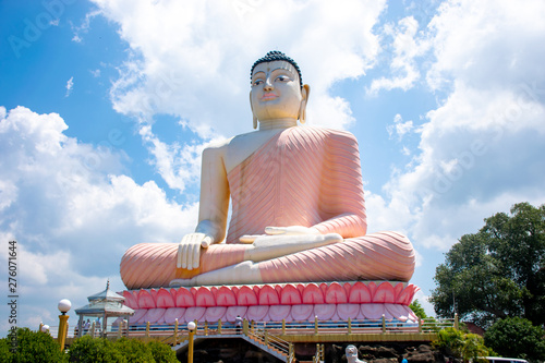 Buddha statue at the Kande Vihara Temple with Cloudy Blue Sky, Bentota. Kande Viharaya is a major Buddhist temple near Bentota beach in Sri Lanka.