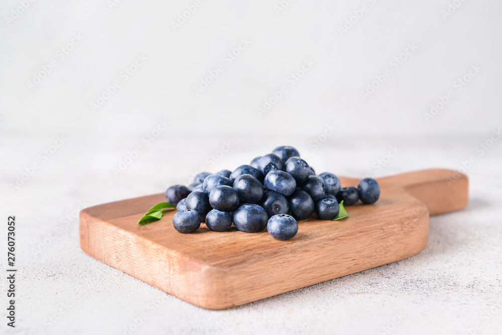 Board with ripe blueberry on light background Board with ripe blueberry on light background