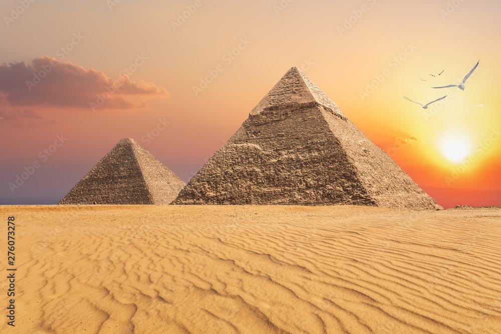 The Pyramid of Chephren and the Pyramid of Cheops, beautiful sunset view of Giza, Egypt The Pyramid of Chephren and the Pyramid of Cheops, beautiful sunset view of Giza, Egypt