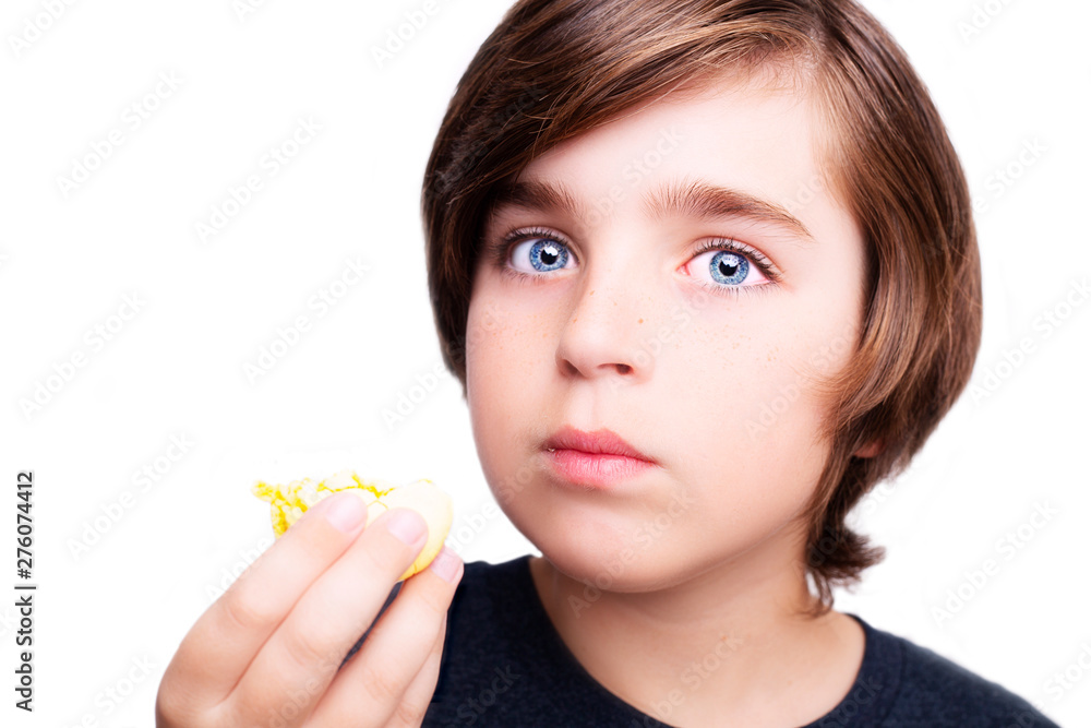 Handsome boy holds in his hands macaroni over white background. Handsome boy holds in his hands macaroni over white background.