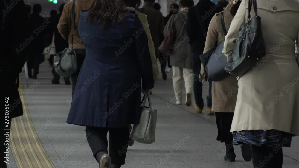 TOKYO, JAPAN - CIRCA APRIL 2019 : Scenery of RUSH HOUR at SHINJUKU. Back shot of unidentified crowd of people going back to home from work at night. TOKYO, JAPAN - CIRCA APRIL 2019 : Scenery of RUSH HOUR at SHINJUKU. Back shot of unidentified crowd of people going back to home from work at night.