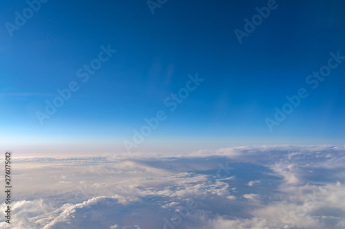 View of dark blue sky horizon, up in the air. viewed from an airplane window photo