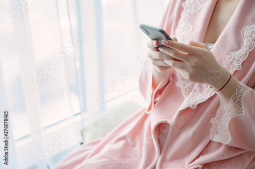 Young woman in underwear with a mobile phone