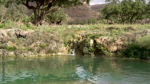 blue water with small waterfall up in the mountains of Salalah, Oman in May. photo