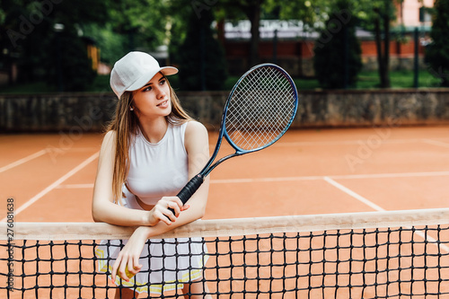 A pretty, young female tennis player serious on court. Sport life.. photo