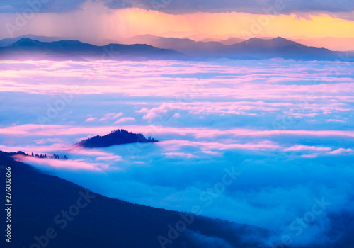 Misty clouds in the mountains at sunrise