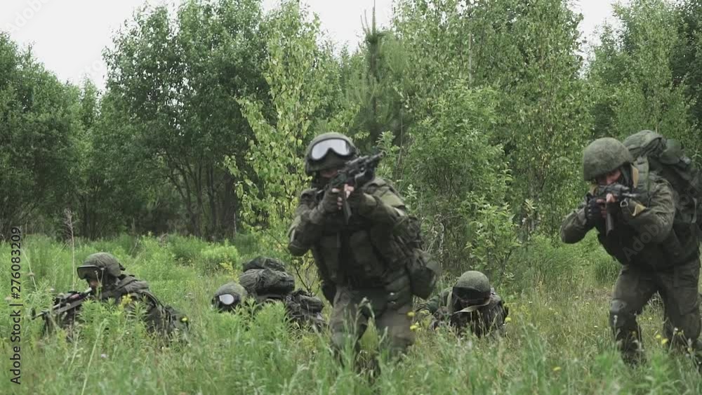 Soldiers in camouflage with assault rifles, out of the ambush in the field, military action in the steppe area. Soldiers in camouflage with assault rifles, out of the ambush in the field, military action in the steppe area.