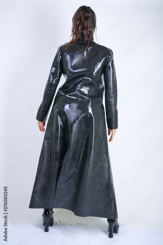 Plus size woman in latex suit and leather boots in thick heavy rubber raincoat on white background in Studio. hot fashionable adult girl posing in fetish clothes alone isolated hot Plus size woman in latex suit and leather boots in thick heavy rubber raincoat on white background in Studio. hot fashionable adult girl posing in fetish clothes alone isolated hot