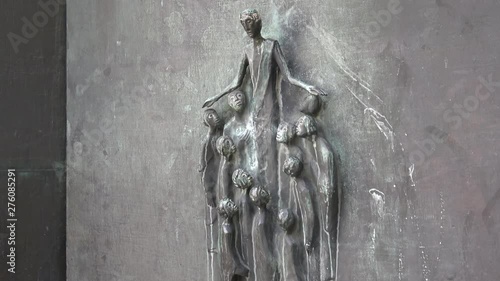 Emotional  iron sculpture of a mother and children on the entrance to a church. Gimble  motion shot photo