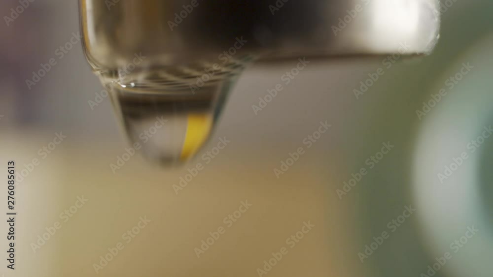 Macro shots of a dripping water faucet wasting water Macro shots of a dripping water faucet wasting water