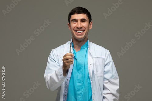 Doctor surgeon with a surgical knife in hand.