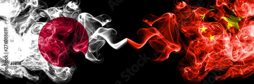 Japan vs China, Chinese smoky mystic flags placed side by side. Thick colored silky smokes combination of China, Chinese and Japanese flag