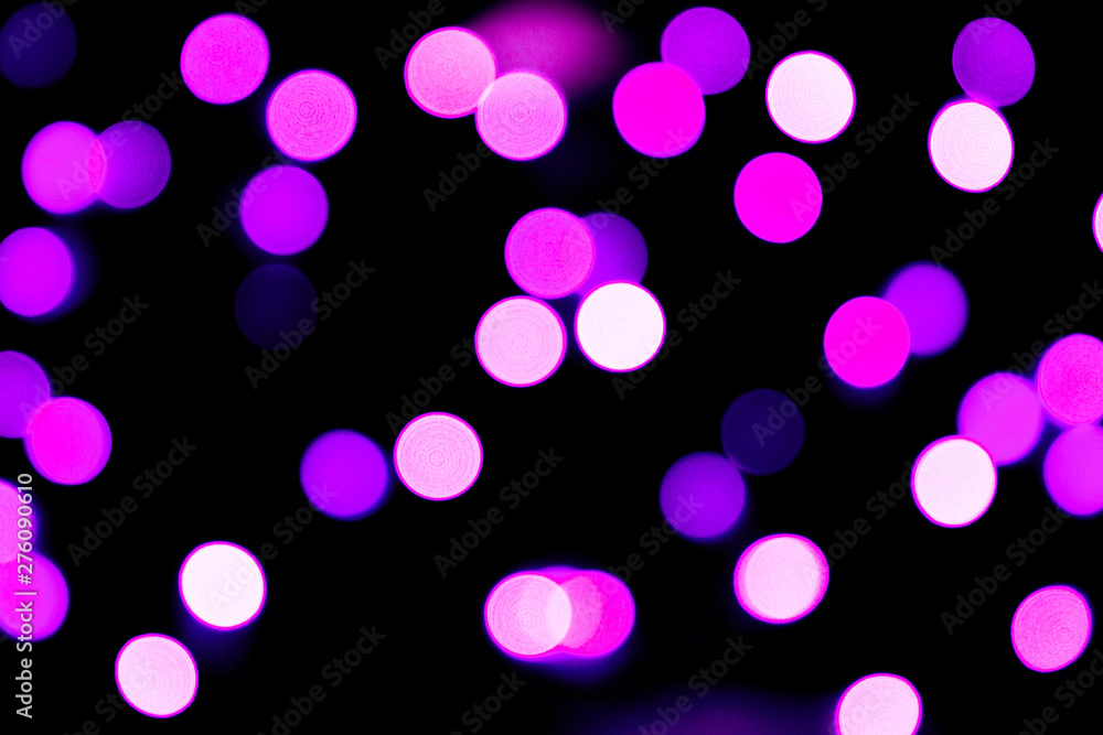 Unfocused abstract purple bokeh on black background. defocused and blurred many round light Unfocused abstract purple bokeh on black background. defocused and blurred many round light
