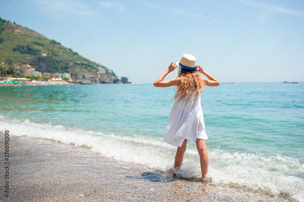 Cute little girl at beach during summer vacation Cute little girl at beach during summer vacation
