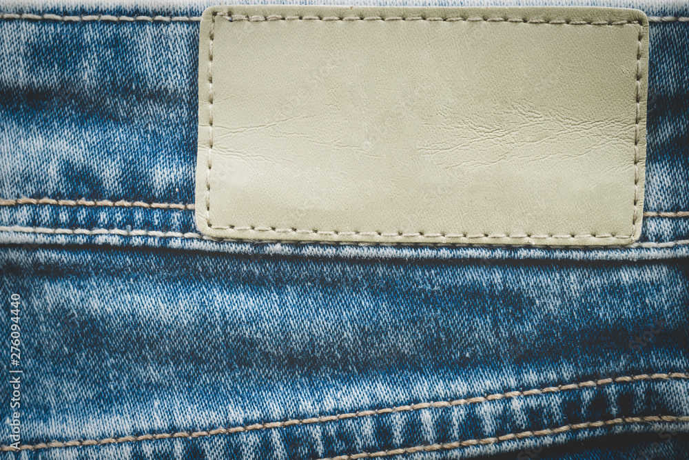 Empty leather label on jeans background with copy space Empty leather label on jeans background with copy space