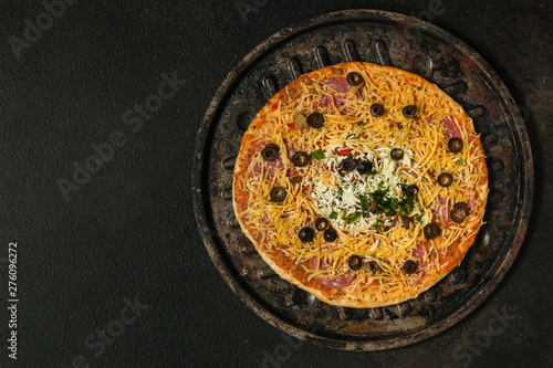 pizza, raw ingredients (frozen dough, olives, meat, sausages, tomato, cheese). Top view. copy space