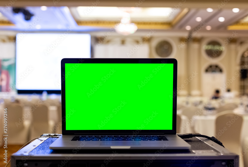 Laptop with blank green screen in seminar room. Laptop with blank green screen in seminar room.
