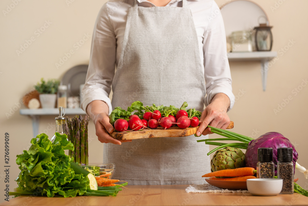 The chef keeps fresh radish for salad. The concept of losing healthy and wholesome food, detox, vegan eating, diet, cooking. Slow food, comfort food, healthy diet, clean eating, horizontal photo The chef keeps fresh radish for salad. The concept of losing healthy and wholesome food, detox, vegan eating, diet, cooking. Slow food, comfort food, healthy diet, clean eating, horizontal photo