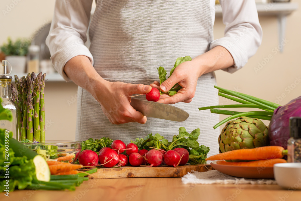 Chef cuts fresh radish for salad. The concept of losing healthy and wholesome food, detox, vegan eating, diet, cooking. Slow food, comfort food, healthy diet, clean eating, horizontal photo Chef cuts fresh radish for salad. The concept of losing healthy and wholesome food, detox, vegan eating, diet, cooking. Slow food, comfort food, healthy diet, clean eating, horizontal photo