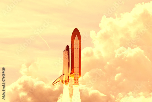 Powerful rocket is flying through the clouds to stars. Elements of this image furnished by NASA.