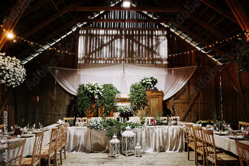 Interior of an old wooden hall with decorated tables.
