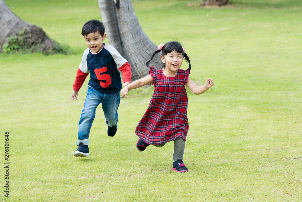 Obraz premium children running and playing in the park with happiness.