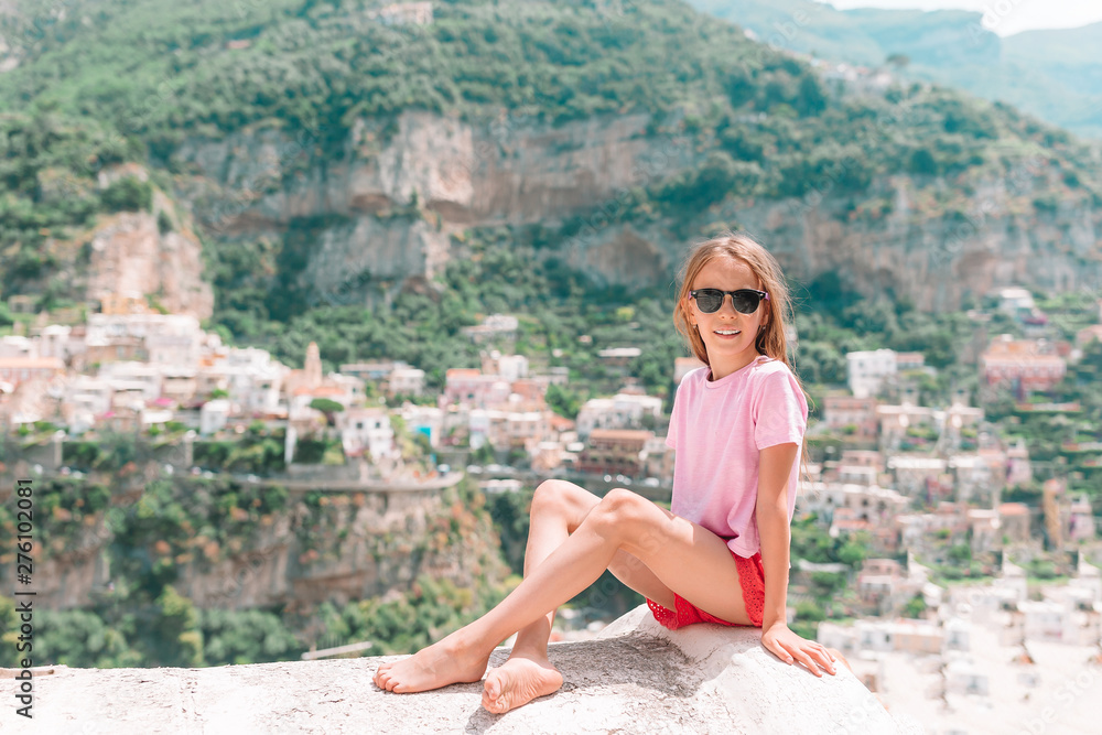 Fototapeta premium Adorable little girl on warm and sunny summer day in Positano town in Italy