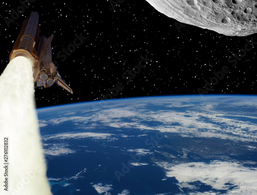 Rocket above earth. Asteroid in outer space. The elements of this image furnished by NASA. photo