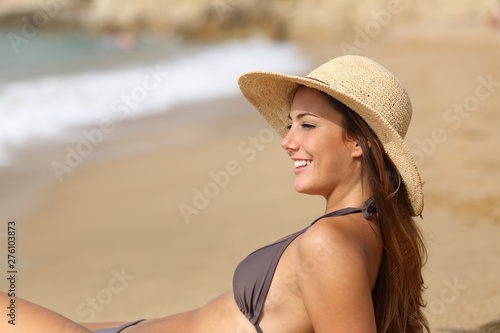 Beauty sunbather contemplating ocean on the beach