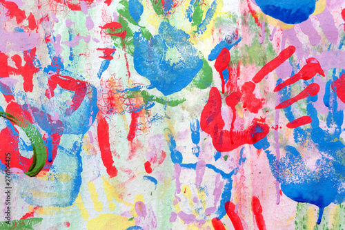 Color background of children's handprints. Multi colored hand prints