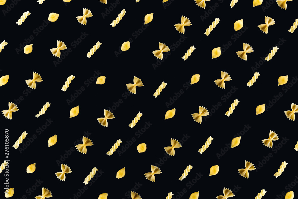 flat lay of different kinds of pasta isolated on black flat lay of different kinds of pasta isolated on black