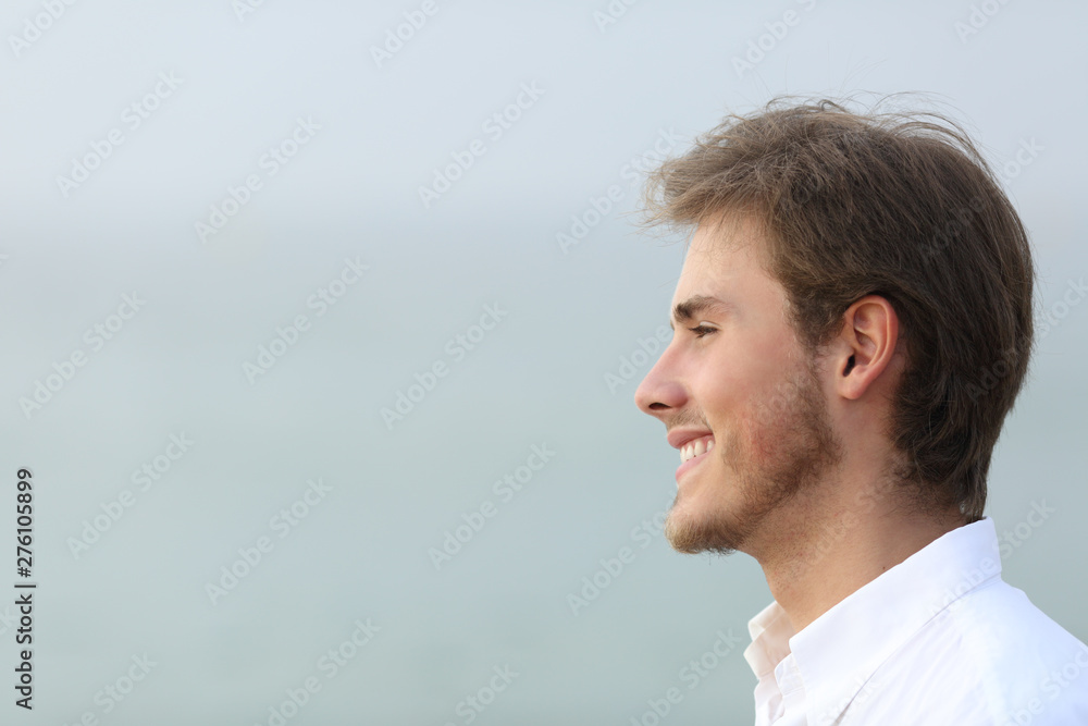 Side view portrait of a happy man on the beach Side view portrait of a happy man on the beach