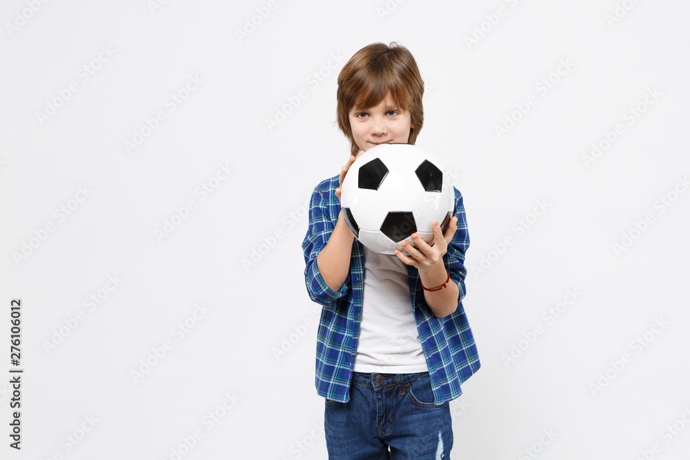 Football fan kid boy blue t-shirt cheer up support favorite team with soccer ball isolated on white wall background children studio portrait. People childhood sport family leisure lifestyle concept.