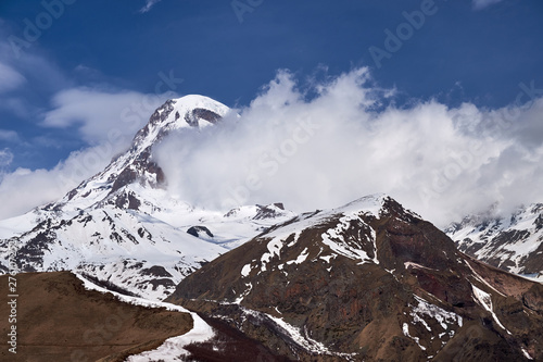 Kazbek mountain peak in the clouds. photo