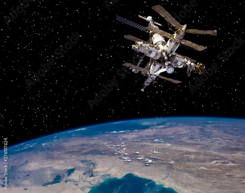 Earth and space station. The elements of this image furnished by NASA.