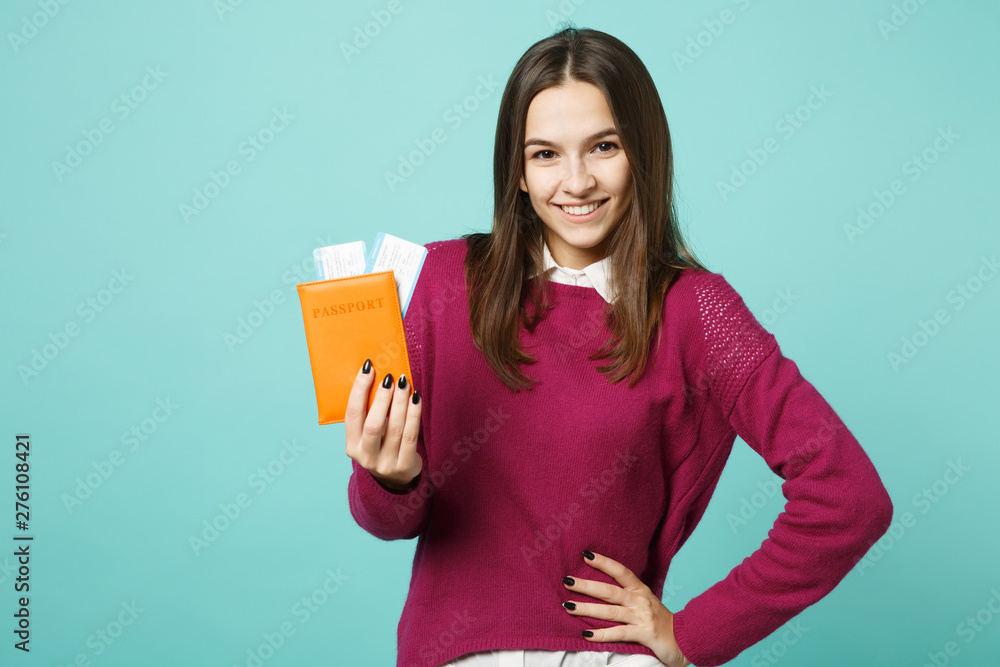 Traveler tourist woman in casual clothes hold passport ticket isolated on blue background studio portrait. Passenger traveling abroad on weekends getaway. Air flight journey concept Mock up copy space Traveler tourist woman in casual clothes hold passport ticket isolated on blue background studio portrait. Passenger traveling abroad on weekends getaway. Air flight journey concept Mock up copy space