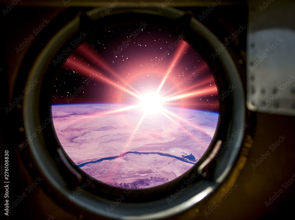 Gorgeous view of sunrise. Window of spaceship. Elements of this image furnished by NASA.