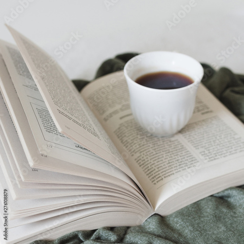 Reading a book and drinking coffee