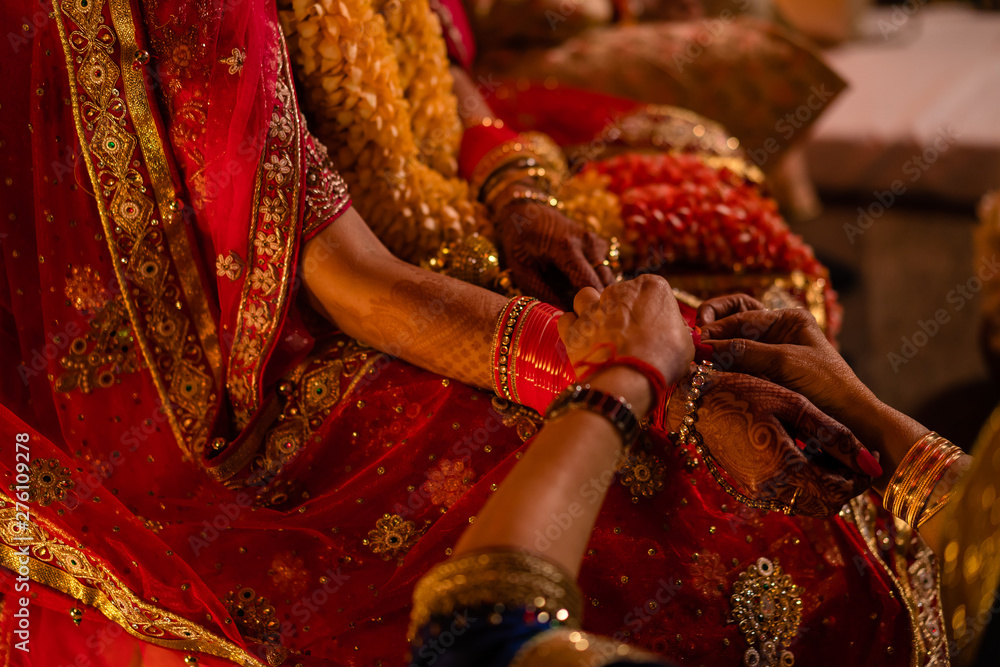 Sacred thread being tied on Hindu bride's wrist