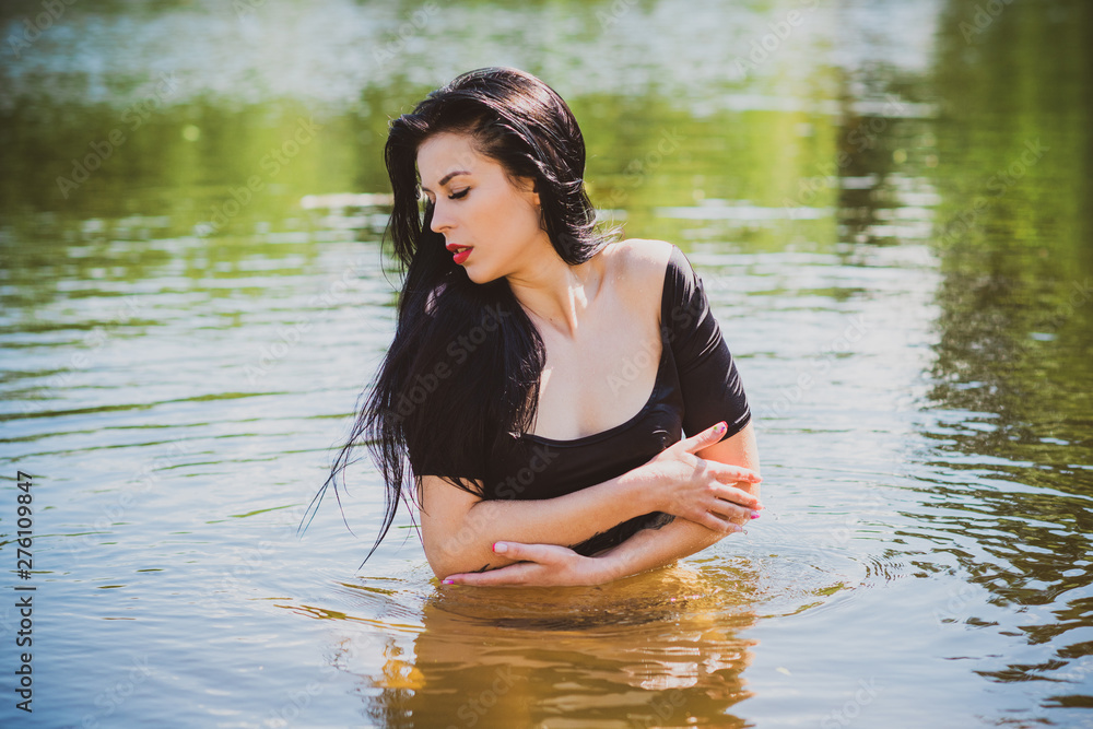 Vacation time. Woman in black swimsuit at summer days Vacation time. Woman in black swimsuit at summer days