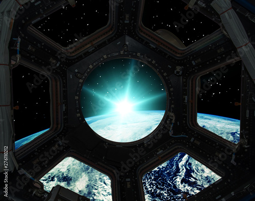 Sunrise from the window of a spaceship. Elements of this image furnished by NASA.