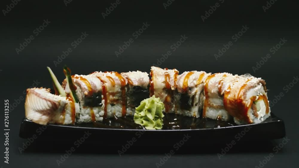 Japanese food composition. Ready-made sushi on a black plate in 4k resolution Japanese food composition. Ready-made sushi on a black plate in 4k resolution