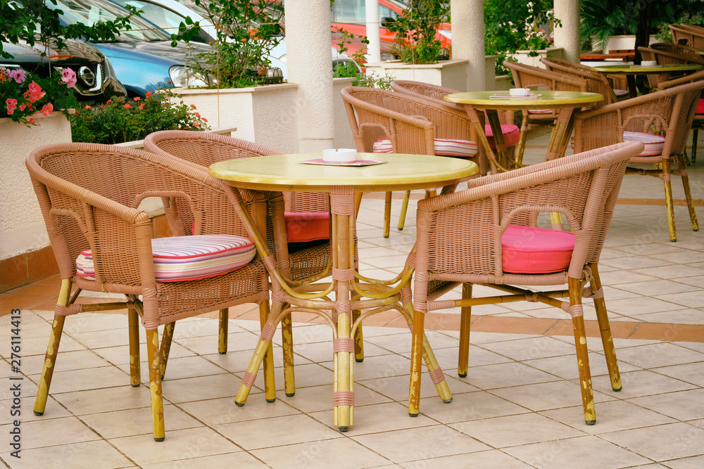 Chairs and tables in outdoor restaurant. Patio in city in suny summer.