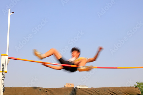 men high jump athletes in the playground
