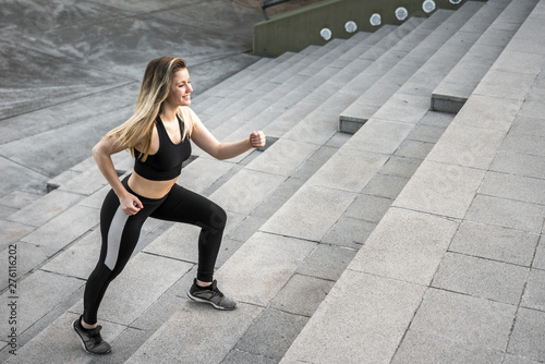 Young woman doing exercises at the street