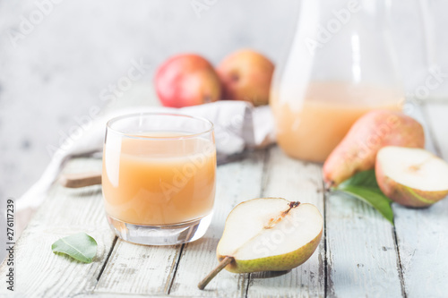 Fresh Pear Juice in a glasses with fresh fruits on light background