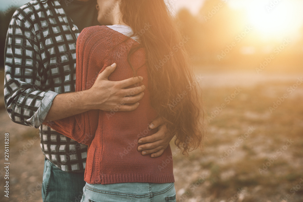 Young loving couple hugging outdoors - obrazy, fototapety, plakaty 